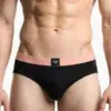 Slip hombre negro Emporio Armani, cinturilla coral con etiqueta águila centrada, vista frontal.