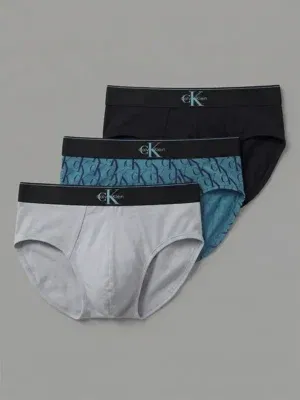 Pack de 3 slips Calvin Klein Low Rise Graphic Monogram con cinturilla ancha en color negro, estampado gris y estampado azul verdoso.