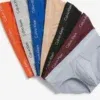 Vista en abanico de los 7 calzoncillos slip anatómicos Calvin Klein Cotton Stretch con cinturilla elástica clásica.
