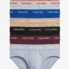 Pack de 7 slips Calvin Klein Cotton Stretch multicolor apilados, mostrando la paleta completa para rotación semanal.