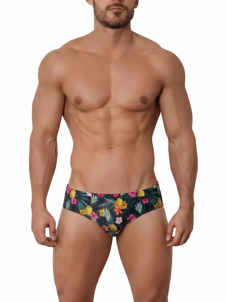 Vista frontal de bañador slip con estampado de piñas e hibiscos sobre fondo oscuro — BLU2553 Beachbrief Olaf Benz