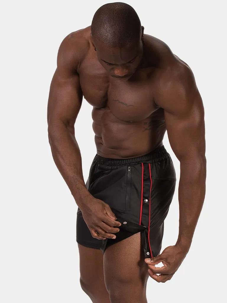 Modelo con short efecto piel negro rojo Fuad de Barcode Berlin abriendo los botones laterales