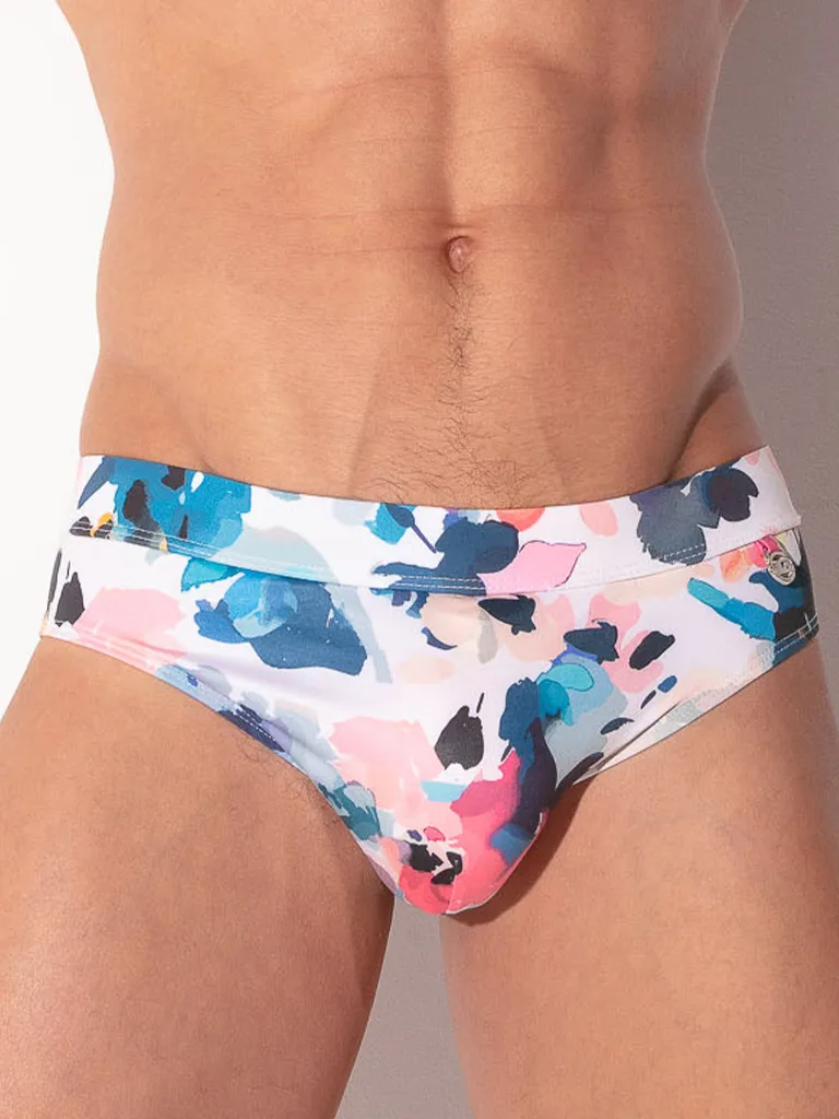 Vista frontal media bañador slip Code 22 London mostrando print acuarela floral y silueta ajustada