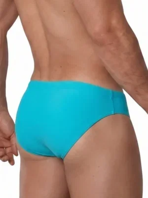 Vista trasera lateral de bañador slip liso azul turquesa con corte Sunbrief — BLU2551 Olaf Benz